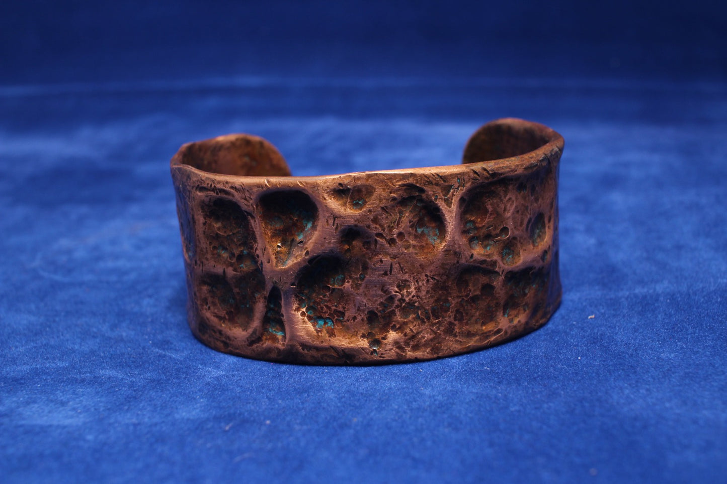 wide hammered copper bangle with a hint of blue patena