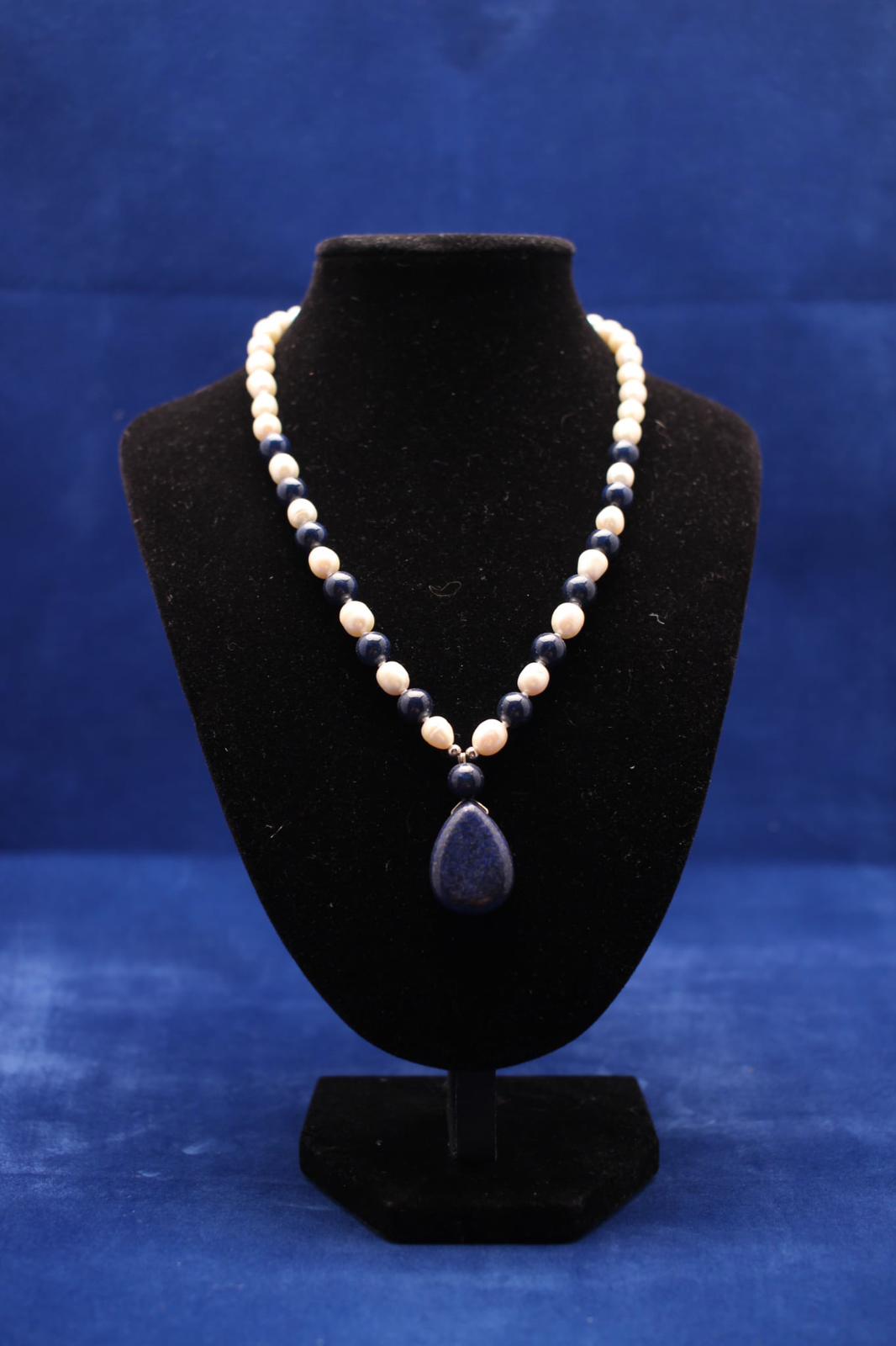 Necklace made from fresh water pearls blue lapis lazuli with sterling silver findings and teardrop shaped pendant