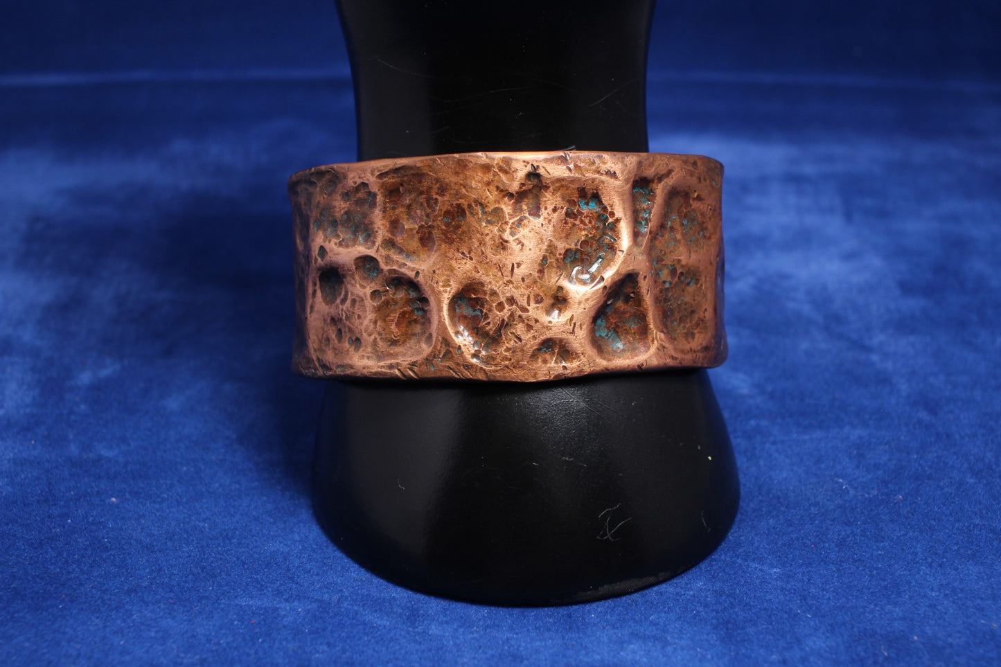wide hammered copper bangle with a hint of blue patena