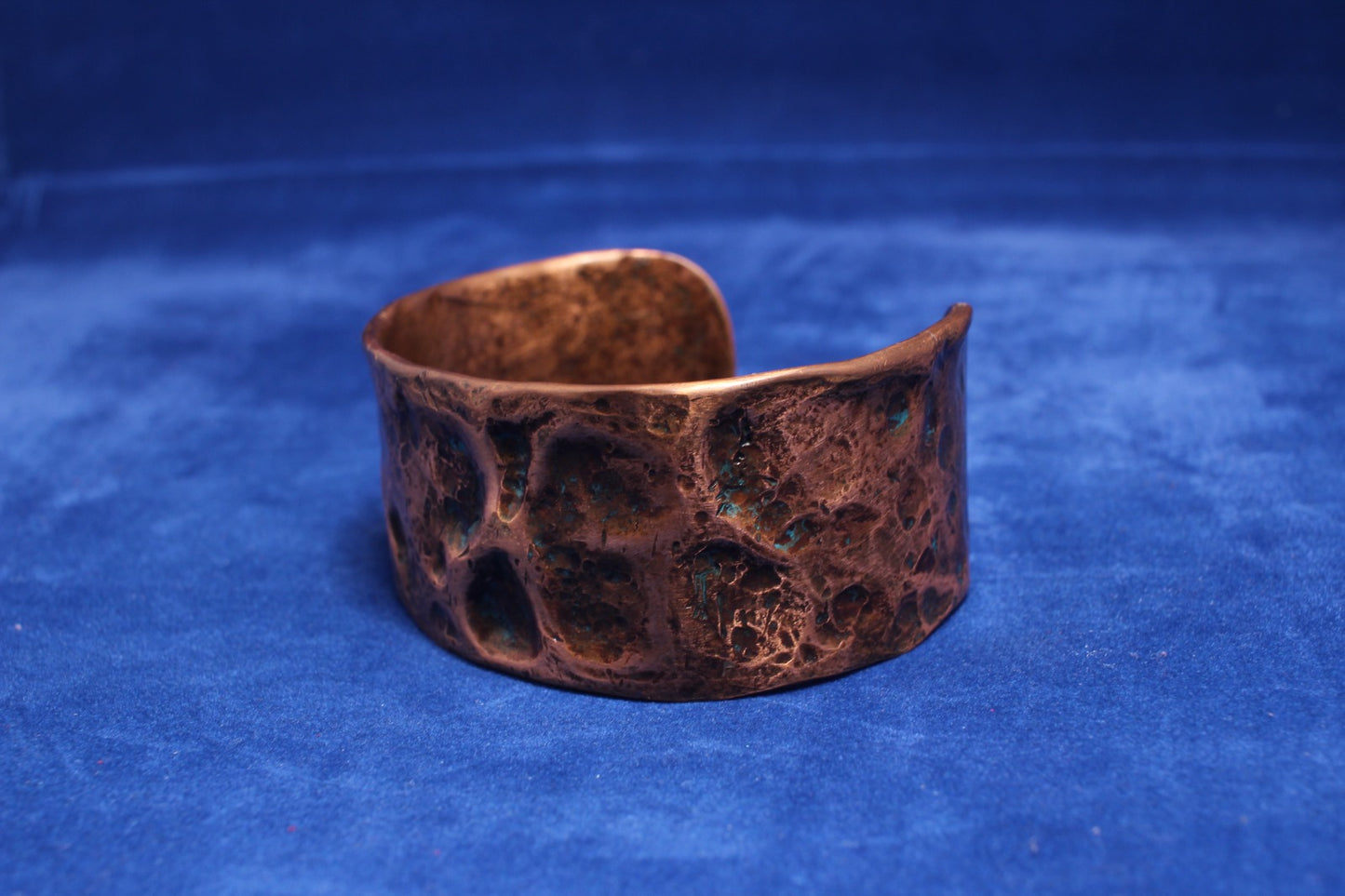 wide hammered copper bangle with a hint of blue patena