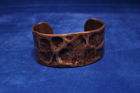 wide hammered copper bangle with a hint of blue patena